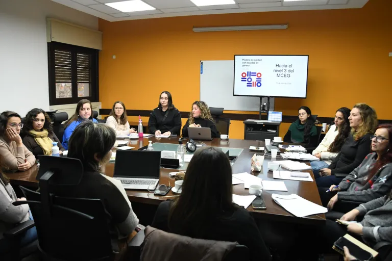 Comité de Género de un servicio unvierstiario reunido alrededor de una mesa